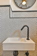 © ADDICTIVE STOCK - Modern bathroom sink with patterned tile backdrop