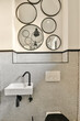 © ADDICTIVE STOCK - Modern bathroom sink with patterned tile backdrop