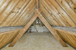 © ADDICTIVE STOCK - Empty attic interior with exposed wooden beams