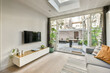 © ADDICTIVE STOCK - Modern living room with view to a cozy garden patio