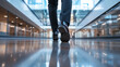 © Maksym - A businessmanâs legs, clad in sharp dress pants and shiny shoes, hurry across a polished floor in a spacious office building, the modern decor of glass and steel framing his rush t