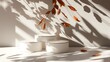 © ProAssets - Three white podiums sit on a white surface with the shadow of fall leaves cast on the wall behind them.