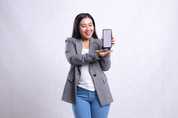 beautiful adult office lady asia gesture happy to mobile phone present holding showing cellphone screen wearing grey suit isolated on white background. for technology, lifestyle, promotion content