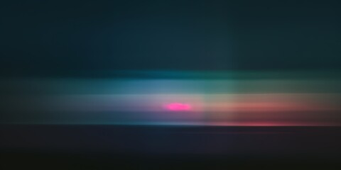 Wall Mural - abstract blur of a colorful sunset over a dark landscape. the pink, orange, and blue hues create a d