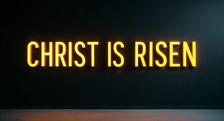 christ is risen word lettering with yellow glow on plain black dark background