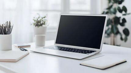 Poster - A white desk with only a laptop and a notebook in a bright indoor office, creating a minimal yet functional workspace, photographed in portrait.