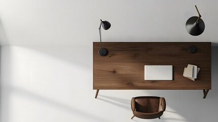 Poster - A birds-eye view of a minimalist workspace with a simple wooden desk, a single chair, and a lamp, set against a white wall.