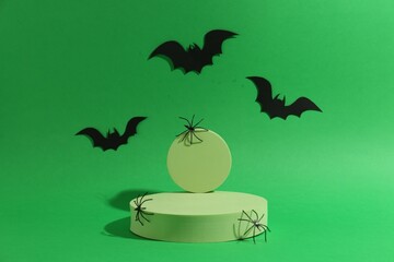 Wall Mural - Presentation of product. Podiums and Halloween decor on green background. Space for text