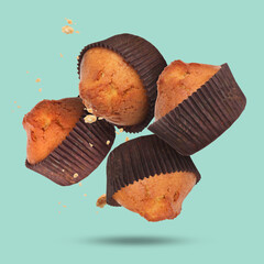 Sticker - Delicious muffins in air on turquoise background