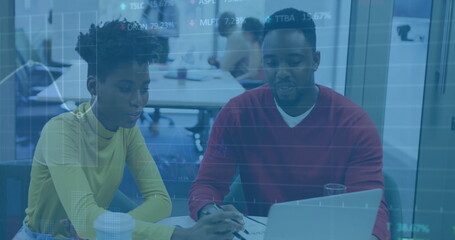 Canvas Print - Image of financial data processing over diverse colleagues discussing work in office