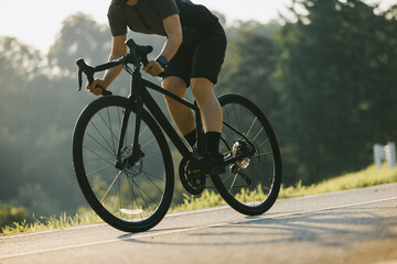 Wall Mural - Woman cycling on summer park trail