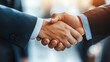 © WS Studio 1985 - Two business professionals shake hands, symbolizing agreement, partnership, or collaboration in a professional setting.