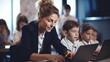 © Iona - A female teacher assists school children working on laptops, fostering an engaged and interactive learning environment in a modern classroom.