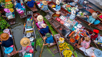 Aerial view Damnoen Saduak floating market, Farmer go to sell organic product, fruit, vegetable and Thai cuisine, Tourist visiting by boat, Ratchaburi, Thailand, Famous floating market in Thailand.