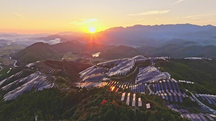 Wall Mural - Aerial photography of solar photovoltaic panels，sunset over the mountains