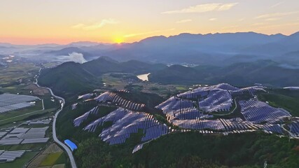 Wall Mural - Aerial photography of solar photovoltaic panels，sunset over the mountains