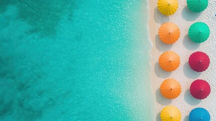 Colorful beach umbrellas on sandy shore with crystal clear turquoise water.