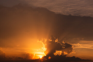 Sunset sky dramatic sunset clouds and sunset sunrays. Beautiful colorful dramatic sky with clouds at sunset or sunrise. Sun rays. Skyscape nature composition. Natural sky background.