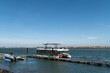 © ako-photography - Tourist boat docked at a waterfront pier on a sunny day by the river