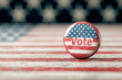 © Wanida - A red, white and blue button with the word Vote on it