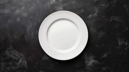 White ceramic plate on black table from above