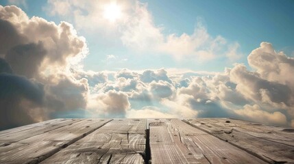 Poster - Weathered wooden table against a hazy blue sky with clouds Picture