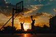 © SaroStock - Two silhouetted basketball players dribble on an outdoor court during sunset with dramatic skies and reflections on the ground