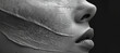 © Alita Creations - image features close up of face with textured, cracked surface, conveying sense of depth and emotion. monochromatic tones enhance dramatic effect, highlighting intricate details of skin