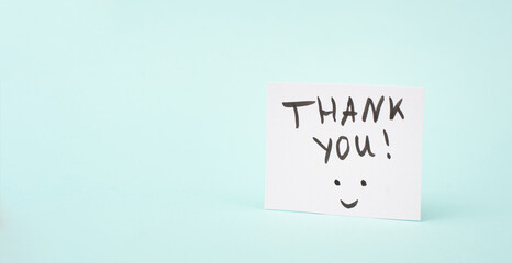 Thank you card with a happy smiling face, being thankful, support, help and charity concept, positive attitude 