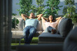 © Antonioguillem - Couple relaxing on a couch in a terrace