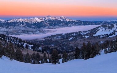 Wall Mural - A serene winter landscape at dusk, showcasing snow-covered mountains and a valley shrouded in mist.