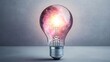 © Kankamol Tama - Electric light bulb with a glowing nebula inside, surrounded by ambient cosmic dust, representing the limitless potential of the universe