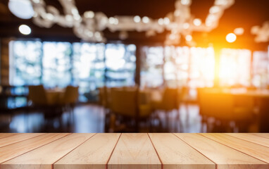 Wall Mural - Empty wooden table top with lights bokeh on blur restaurant background.	