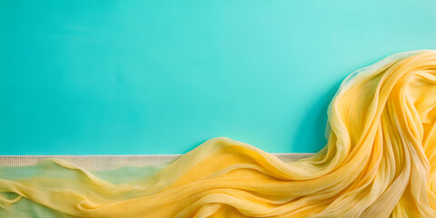 Poster - flowing yellow fabric on turquoise background
