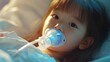 © Nathan - A young Asian girl with a pacifier, gazing curiously from a hospital bed, evoking a sense of innocence and vulnerability.