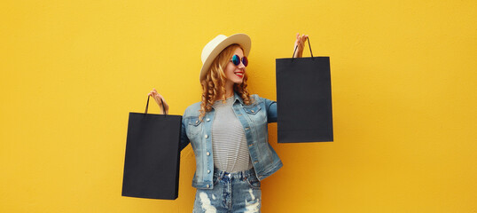 Wall Mural - Shopping day, stylish beautiful happy smiling young woman with black shopping bags, wear summer hat