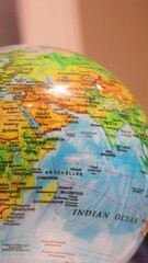 India, the Indian Ocean, Seychelles, and Mauritius are depicted on a rotating globe of the world in a vertical video format.