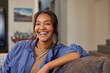 © Rido - Laughing indian woman on sofa at home