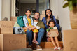 © Rido - Happy multiethnic family smiling after moving home