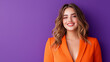© Denis Yevtekhov - smiling young woman in a modern orange pantsuit posing confidently against a bold purple background fashion model bold colors smiling young woman