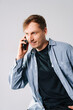 © Vadim - Young man talking on the phone in a casual setting.