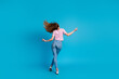 © deagreez - Full body photo of attractive young woman dance fluttering hair back view dressed stylish pink clothes isolated on blue color background