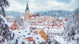 Winter in Cesky Krumlov, with snow-covered rooftops, the castle in the background, and a quiet, serene atmosphere enveloping the town.