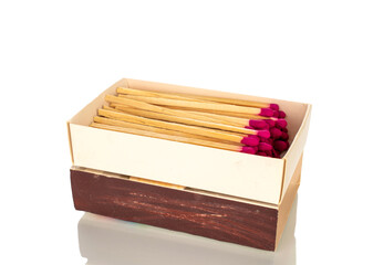 Wall Mural - Wooden matches in a paper box for lighting a fire, macro, isolated on a white background.