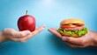 © Marko - One hand holding apple fruit, other holding hamburger. Healthy natural organic fresh vegetarian food vs unhealthy processed fast junk food