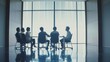 © VK Studio - Silhouetted business meeting in a modern office with a large, bright window backdrop, highlighting the sleek, professional environment.