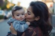 © Rufino - A woman is holding a baby and kissing its face