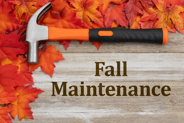 Wall Mural - Fall maintenance message with a hammer on rustic wood