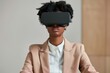 © Vilaysack - A businesswoman in a beige suit explores virtual reality with a VR headset, symbolizing technology, innovation, and the future of work in modern industries.
