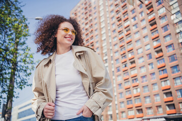 Poster - Photo of pretty adorable girl dressed stylish trench walking in the downtown megapolis sunny weather outdoors